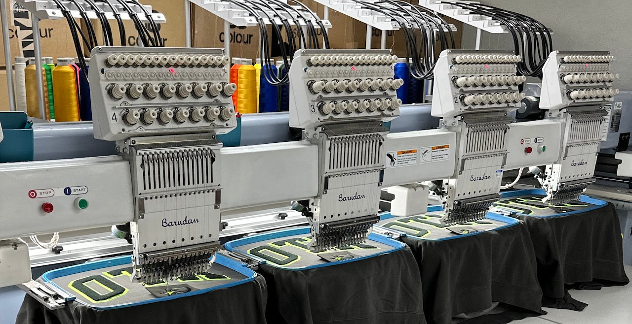 Custom embroidered apparel stitched in-house at Custom Printed Materials